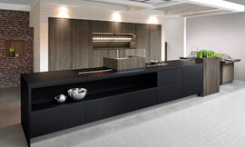 Cocina de diseño purista con los frentes sin tirador. El color negro de la isla se funde con el color de madera oscuro Late Oak de los armarios altos y crea una bonita composición. Zuordnung: Stil Cocinas de diseño, Planungsart Cocinas con isla