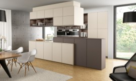La elección de los colores blanco magnolia y moca, combinado con la distribución de la luz y los diferentes materiales empleados ayudan a construir una sensación de espacios diferentes unidos por la elegancia que trasmite esta sala. Pero los muebles de esta cocina con isla también esconden innovaciones, como los muebles altos sobre la encimera o los muebles colgantes sobre la isla, que ayudan a facilitar el trabajo en la cocina. Zuordnung: Stil Cocinas de diseño, Planungsart Cocinas americanas (abiertas)