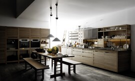 Cocina de madera, de hoy, de ayer y de siempre. Los muebles de madera, las estanterías abiertas y el banco de madera en el centro nos trasladan a otro tiempo. Los electrodomésticos colocados siguiendo los principios de ergonomía y la distribución de la luz nos permiten disfrutar de un agradable y cómodo día a día en nuestra cocina. Y los armarios sin tiradores nos aportan el toque de diseño y de estilo que convierten a esta cocina en un clásico. Zuordnung: Stil Cocinas de diseño, Planungsart Cocinas americanas (abiertas)